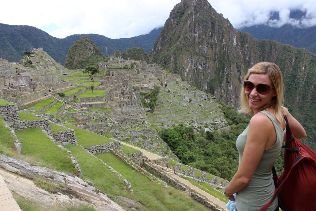 Girl smiling overlooking Machu Picchu, Peru
