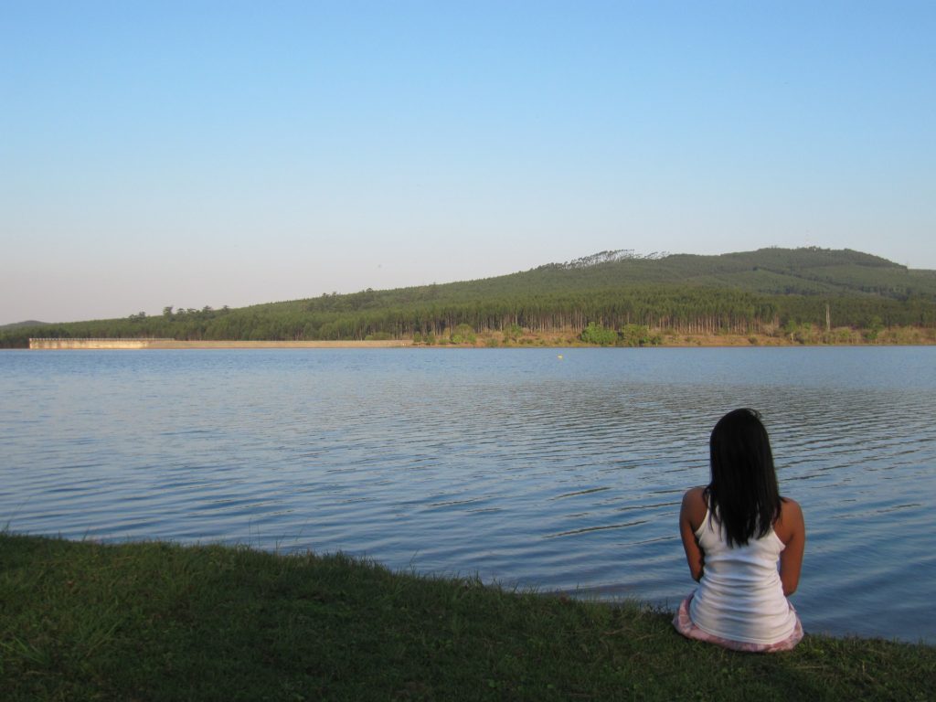 Woman sitting next to water in South Africa