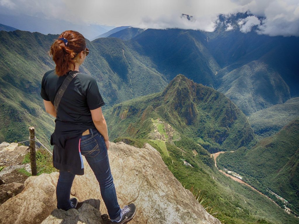 Woman standing overlooking Machu Picchu, in Peru