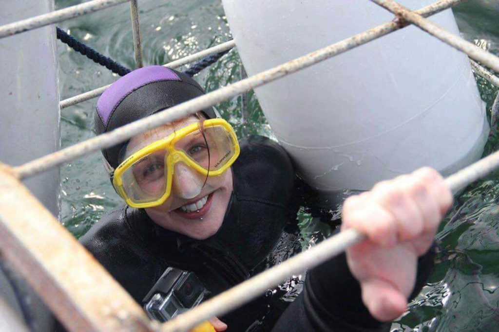 Happy girl in a shark cage